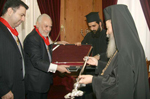 Mr. Kiriakidis offering to His Beatitude a silver warder
