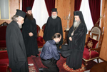Ο δόκιμος Μαρίνος γονυπετής, κρατά το ράσο μπροστά στον Μακαριώτατο